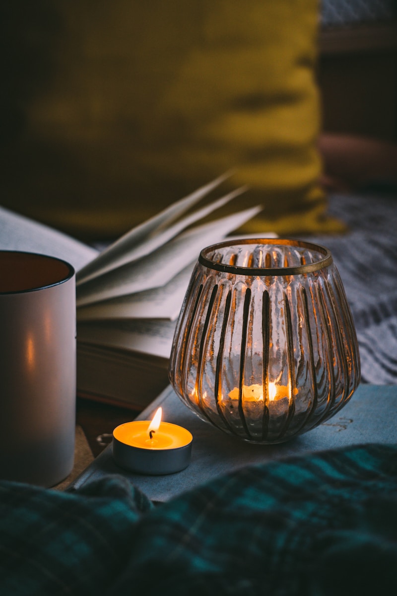Photo by Kat von Wood lighted candle in clear glass candle holder