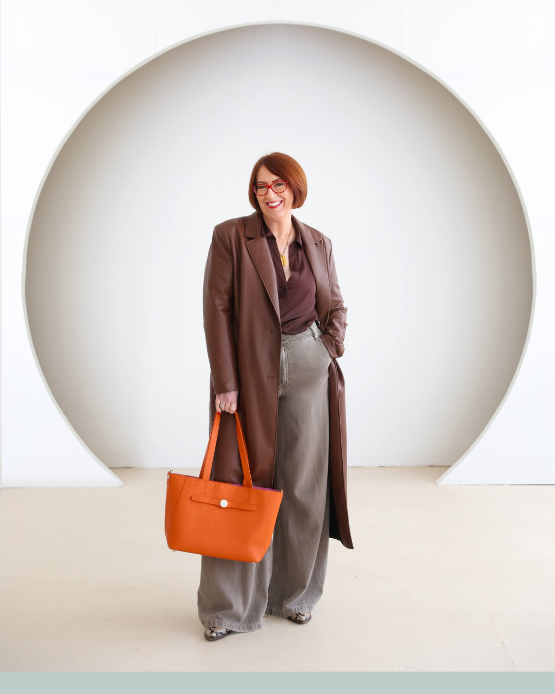 This image is of Jane posing in front of a decorative background.