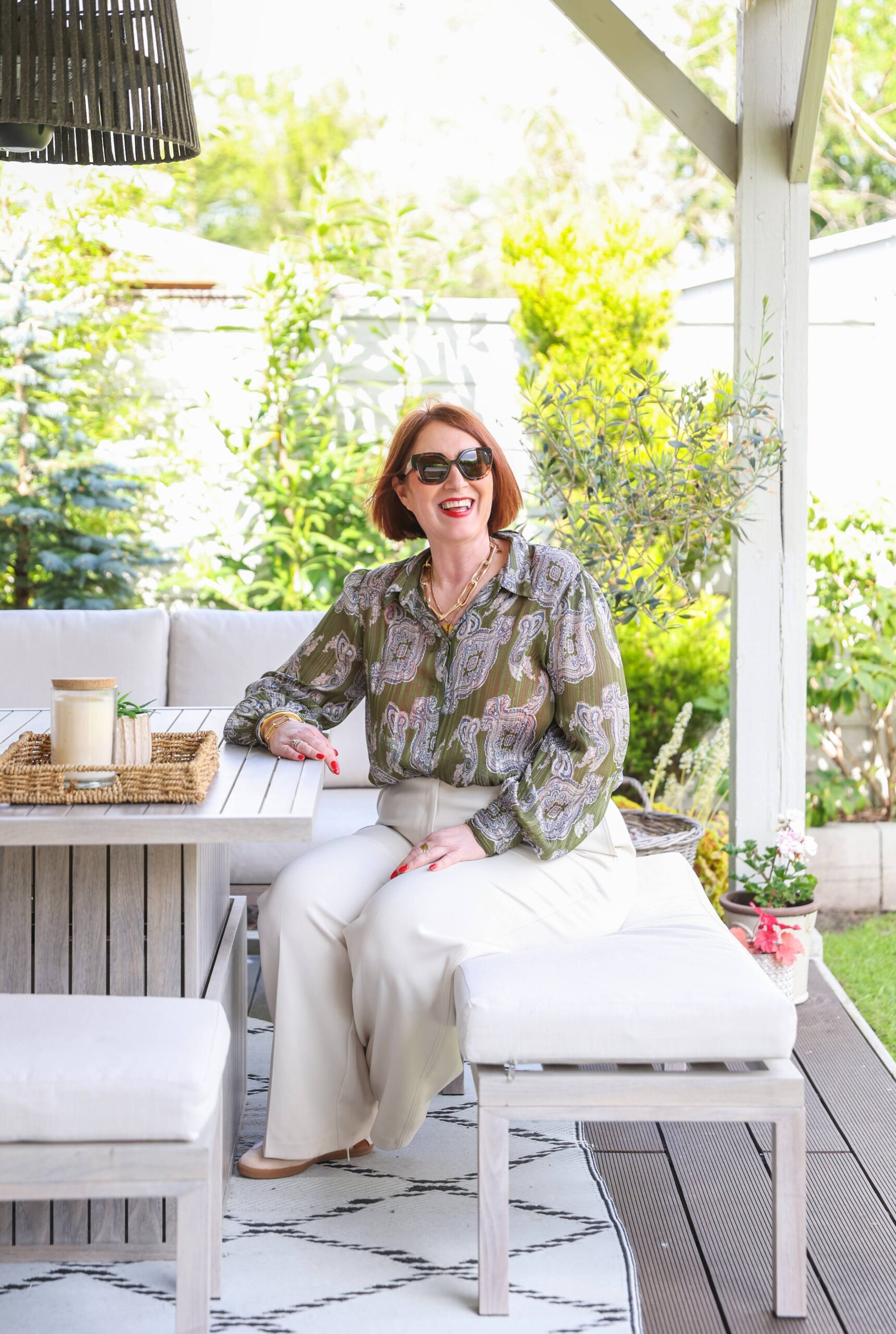 Jane Brook in the garden This photo is of Jane sitting in the garden smiling.