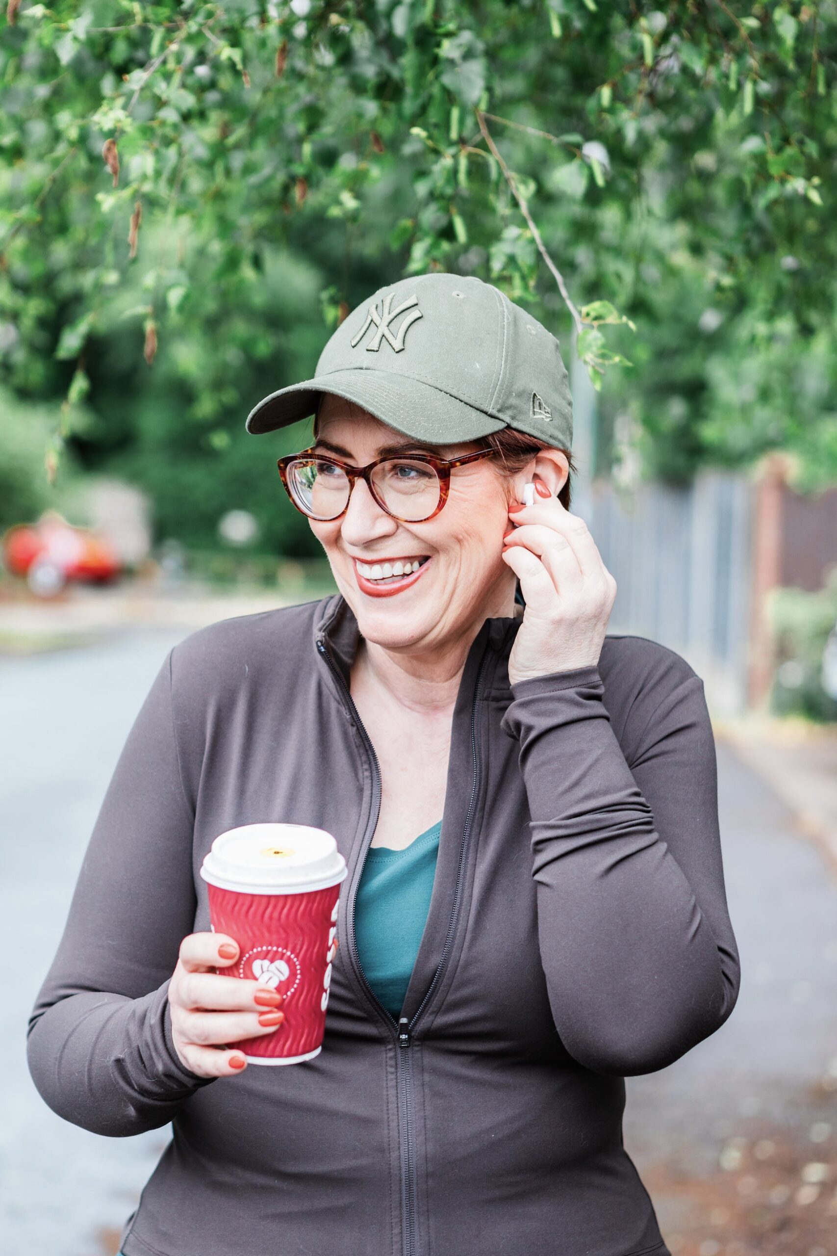 Jane Brook This image is of Jane walking down the road, holding a cup of coffee