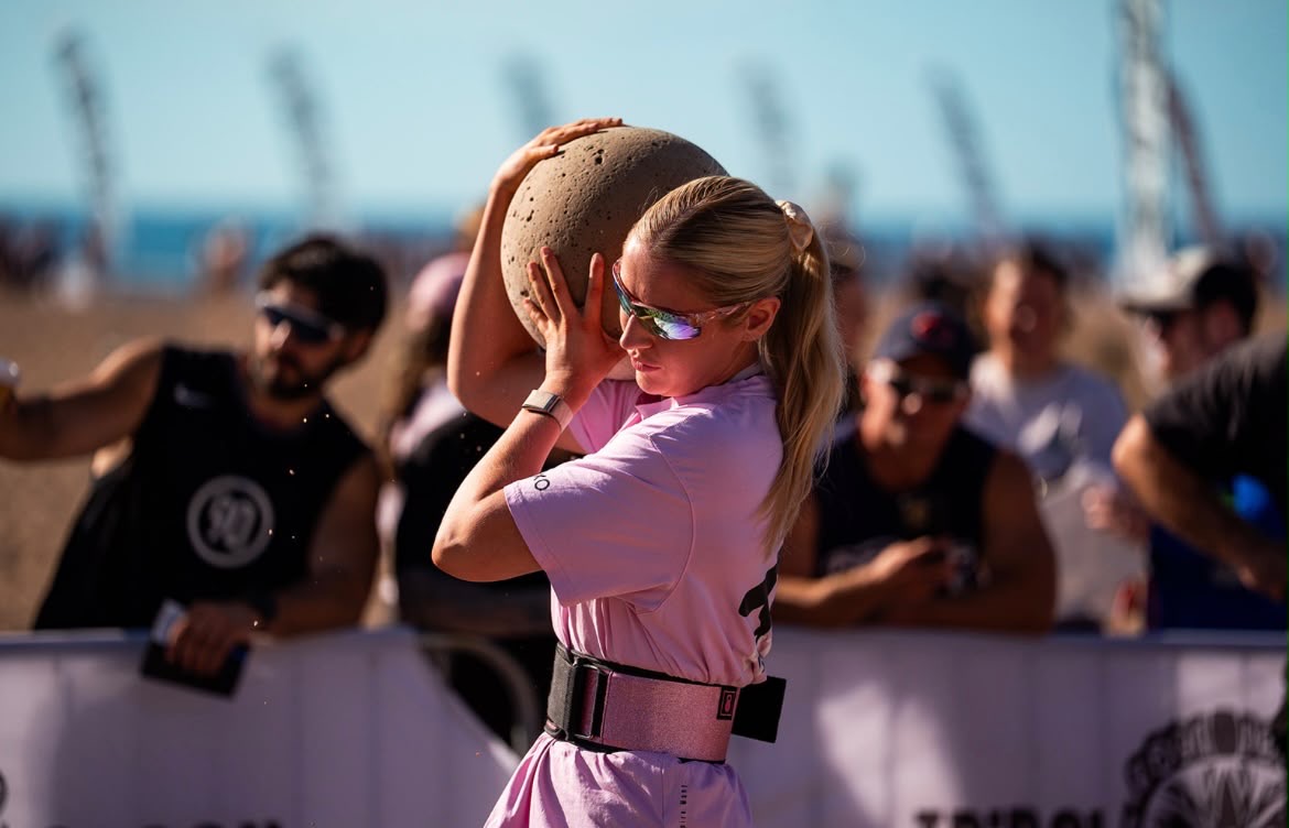 Jane’s Daughter This photo is of Jane's daughter carrying a 45kg Atlas stone.